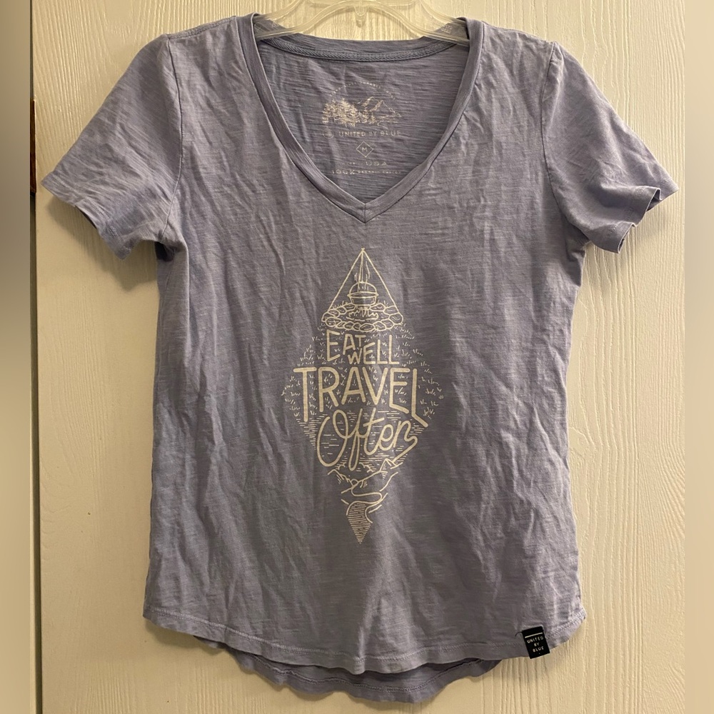 United By Blue Light Blue Graphic Tee “Eat well. Travel often.”